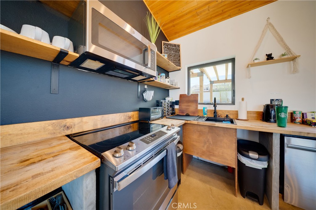 60423 La Mirada Trail Joshua Tree, CA 92252 - Photo 7 of 29 a kitchen that has a sink and a stove