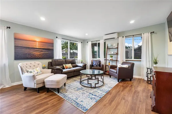 a living room with furniture and wooden floor