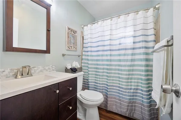 a bathroom with a granite countertop sink a mirror and a