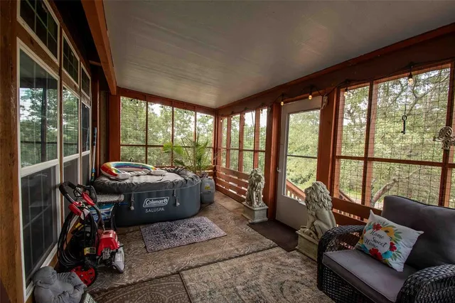 a living room with furniture and floor to ceiling windows