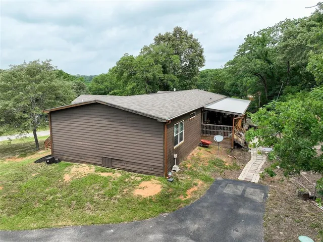 a backyard of a house with large trees