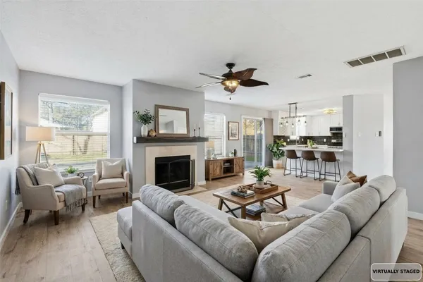 a living room with furniture and a fireplace