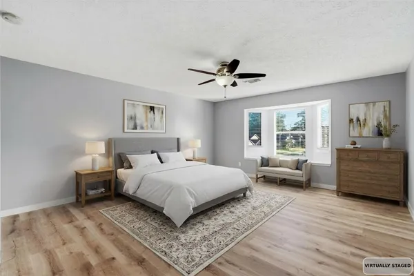 a bedroom with a large bed and a window