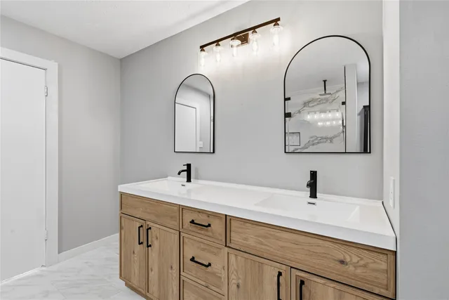 a bathroom with a sink and mirror