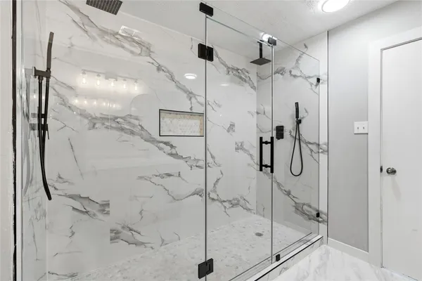 a bathroom with a glass shower door