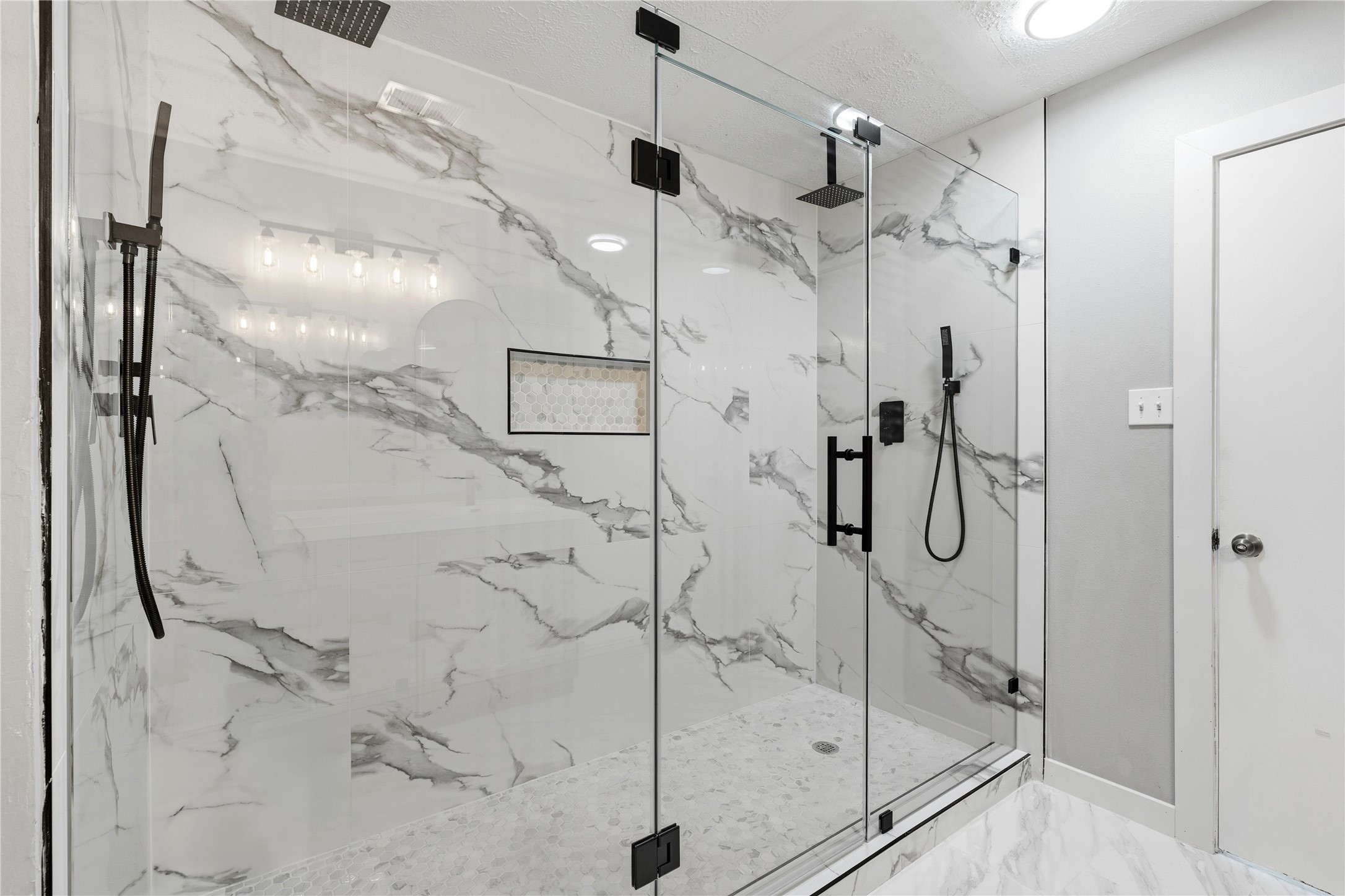 10422 Mist Lane Houston, TX 77070 - Photo 17 of 27 a bathroom with a glass shower door