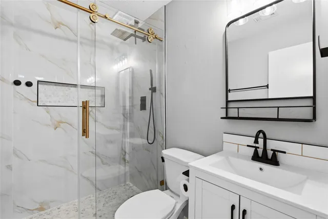 a bathroom with a sink toilet and shower