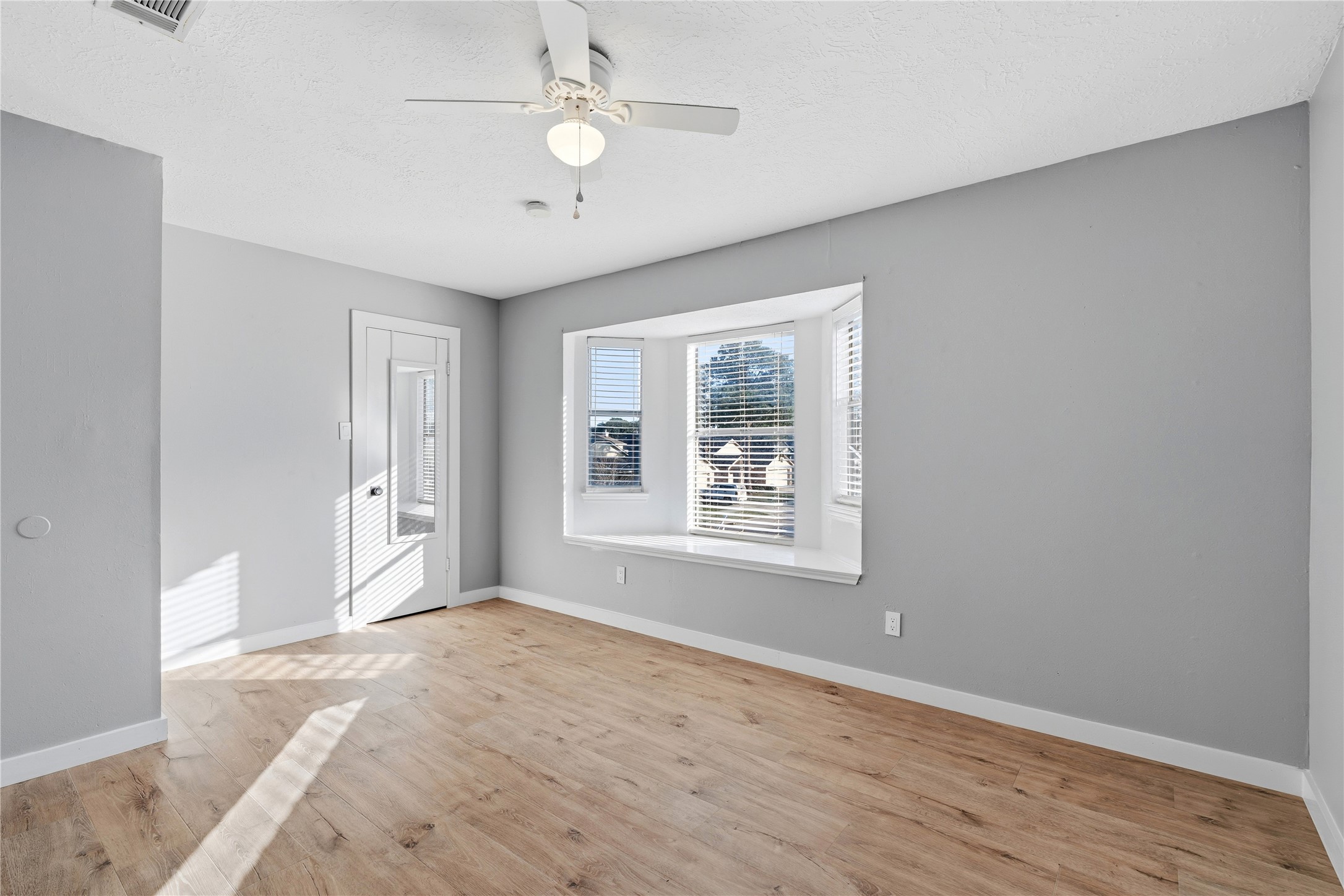 10422 Mist Lane Houston, TX 77070 - Photo 22 of 27 wooden floor in an empty room with a window
