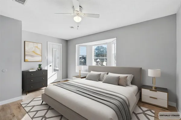 a bedroom with a bed and a lamp on dresser