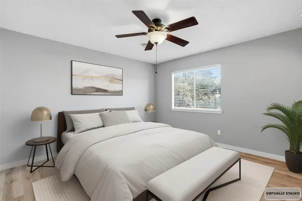 a bedroom with a bed and a painting on the wall