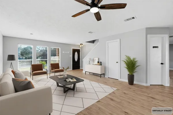 a living room with furniture and a potted plant