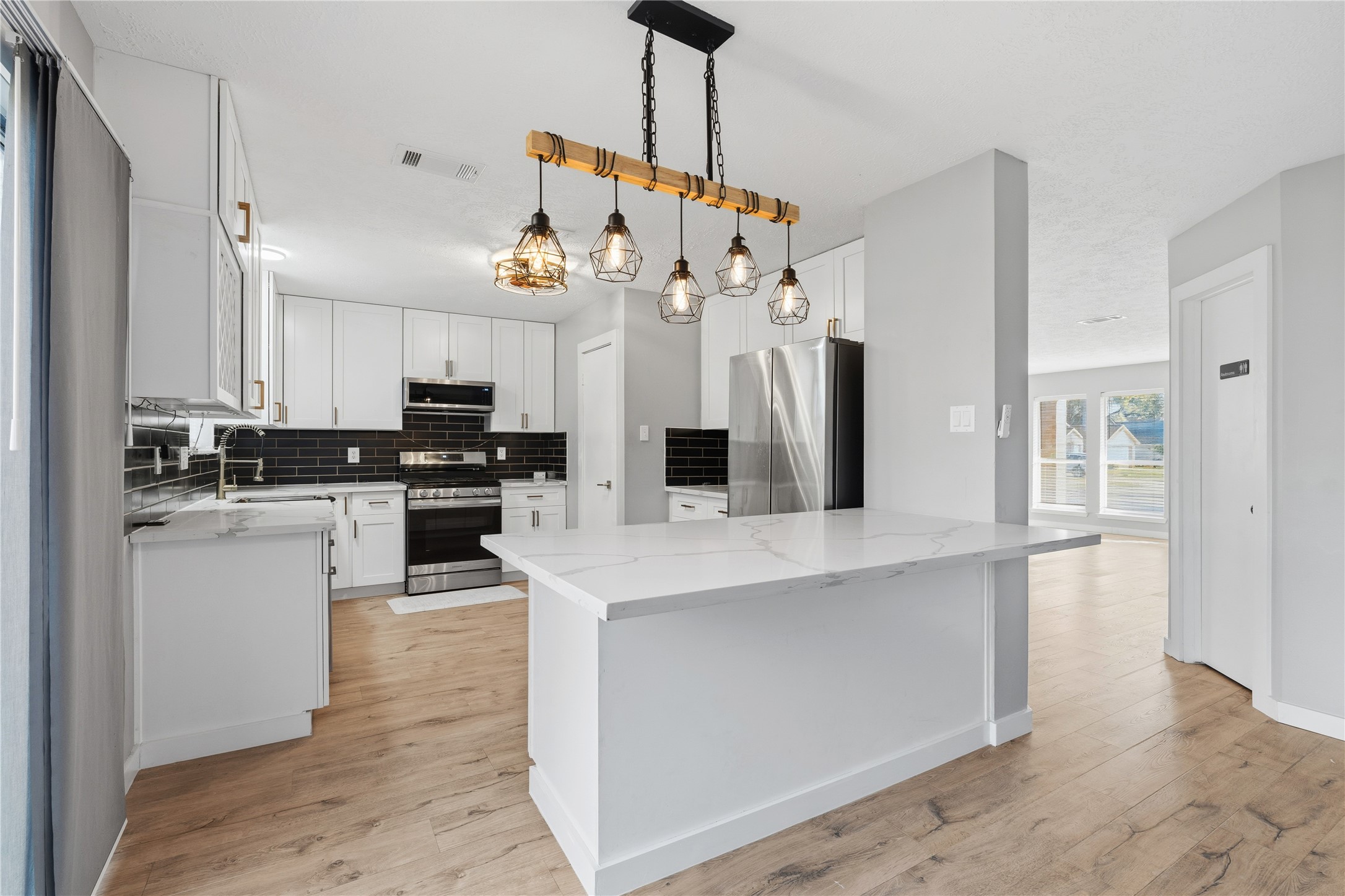 10422 Mist Lane Houston, TX 77070 - Photo 7 of 27 a kitchen with white cabinets and refrigerator