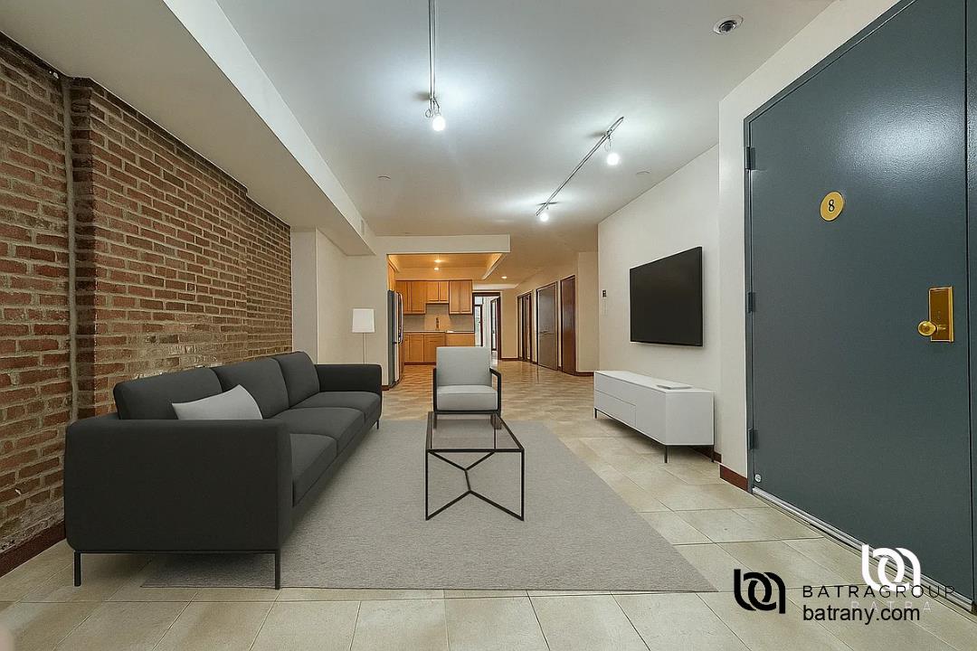 6 East 126th Street, Unit 1 Manhattan, NY 10035 - Photo 1 of 18 a living room with furniture and a flat screen tv