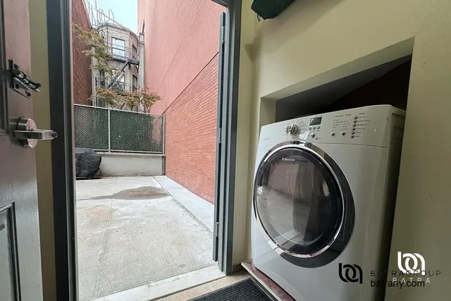 a view of a hallway with washer and dryer