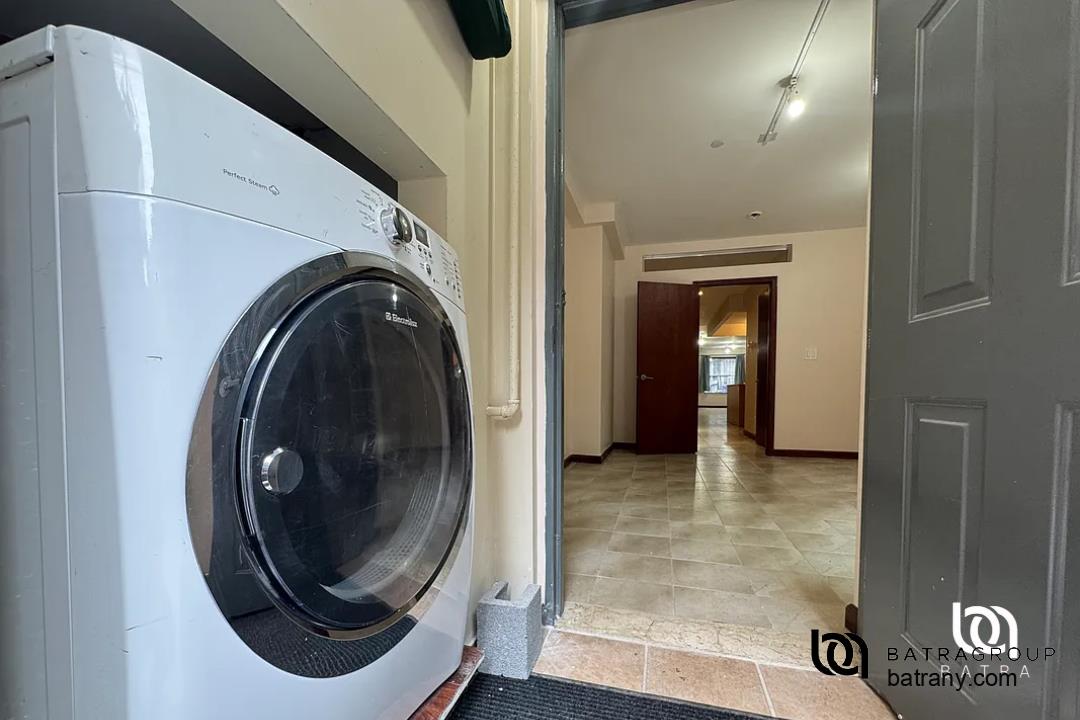 6 East 126th Street, Unit 1 Manhattan, NY 10035 - Photo 13 of 18 a view of a hallway with washer and dryer