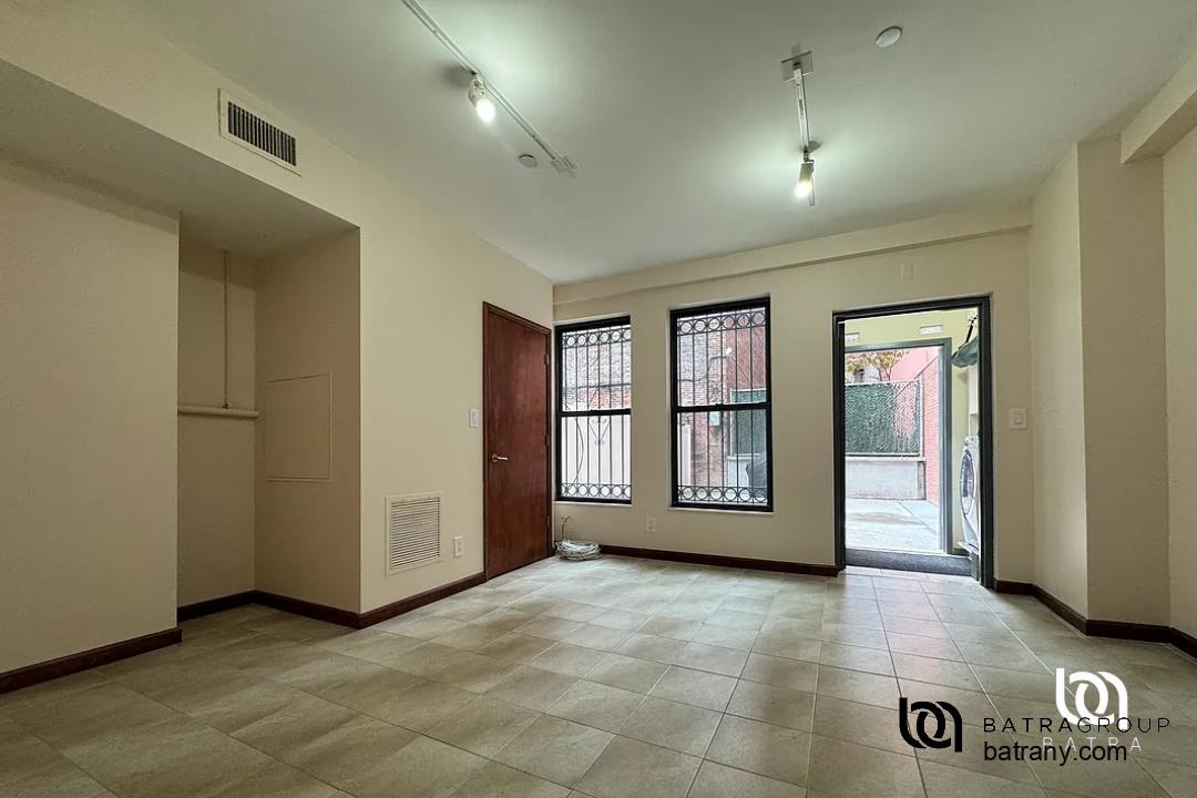 6 East 126th Street, Unit 1 Manhattan, NY 10035 - Photo 16 of 18 a view of an empty room and window