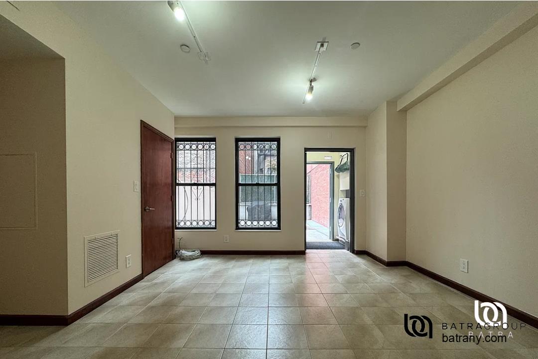 6 East 126th Street, Unit 1 Manhattan, NY 10035 - Photo 17 of 18 an empty room with windows