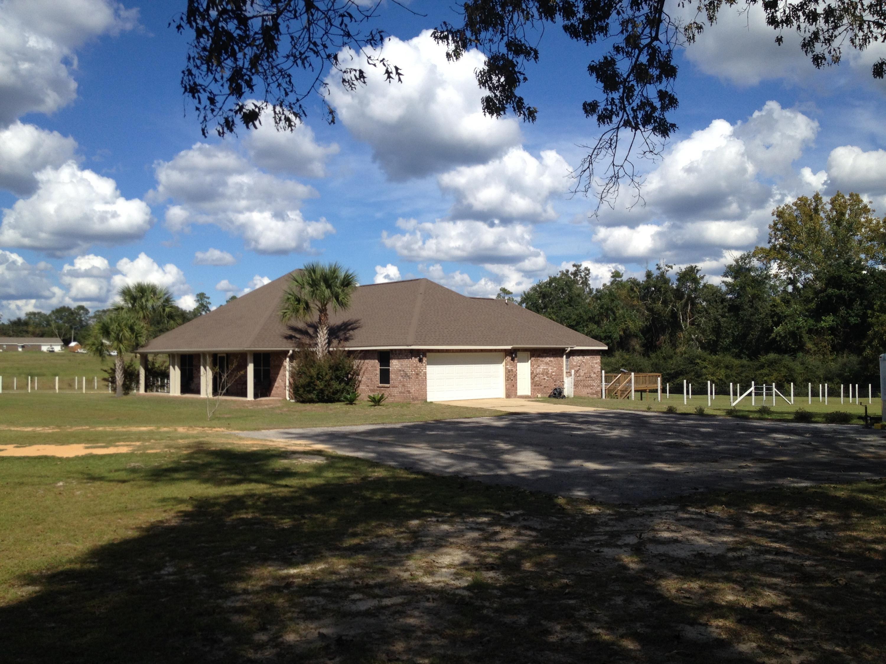 6589 Old River Road, Unit 3 ACRES Baker, FL 32531 - Photo 3 of 30 a front view of a house with a yard