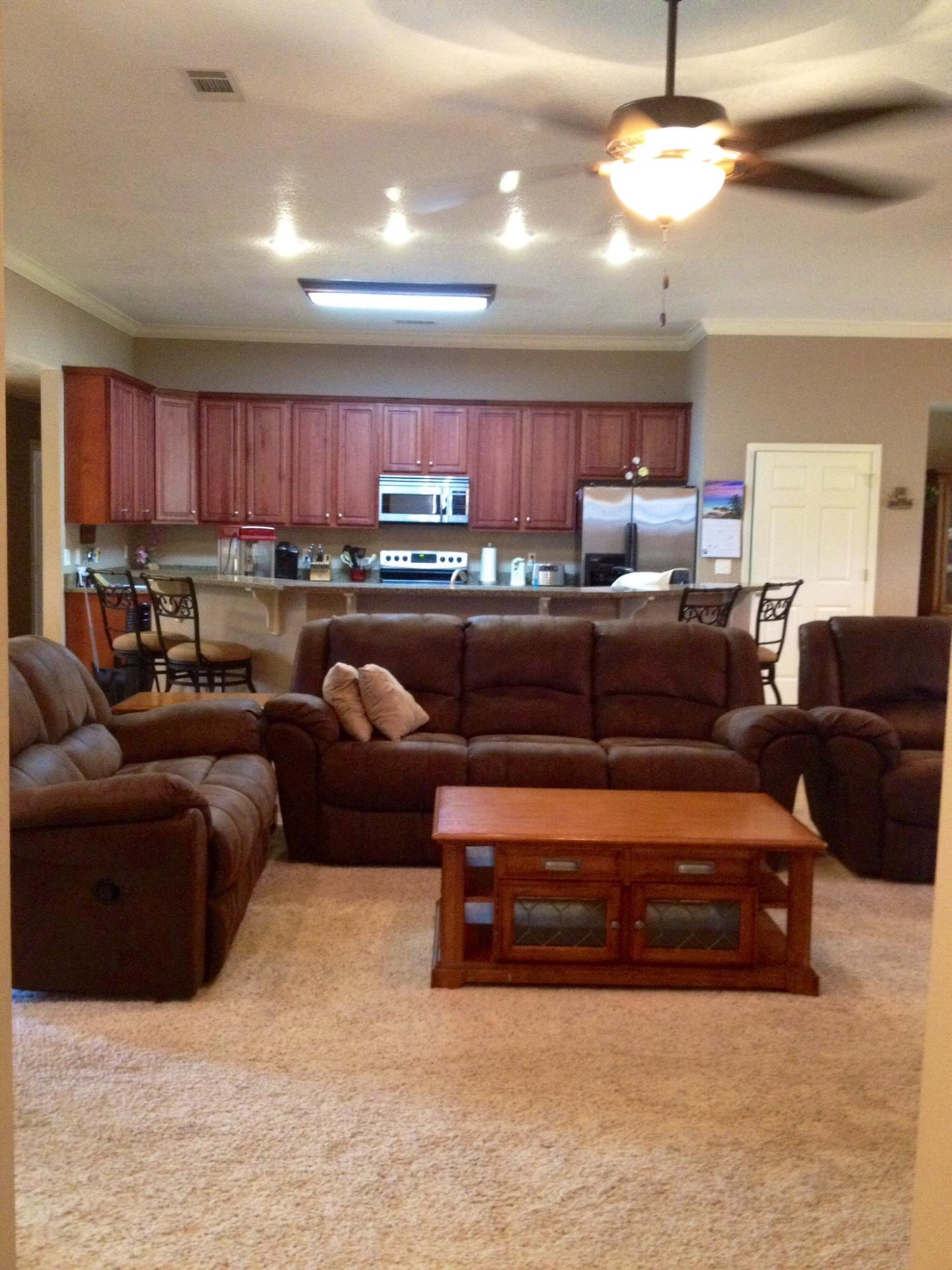 6589 Old River Road, Unit 3 ACRES Baker, FL 32531 - Photo 5 of 30 a living room with furniture a kitchen and a chandelier