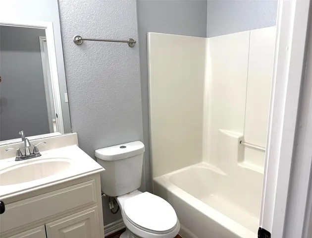 a white toilet sitting next to a bathroom sink