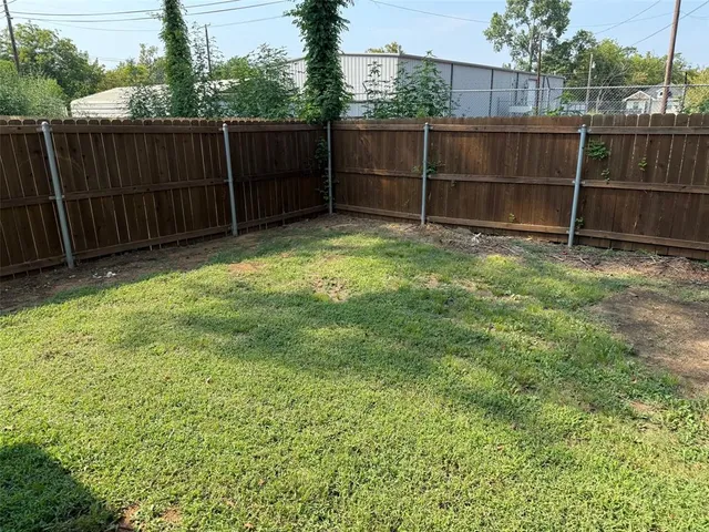 a view of a backyard with a fence