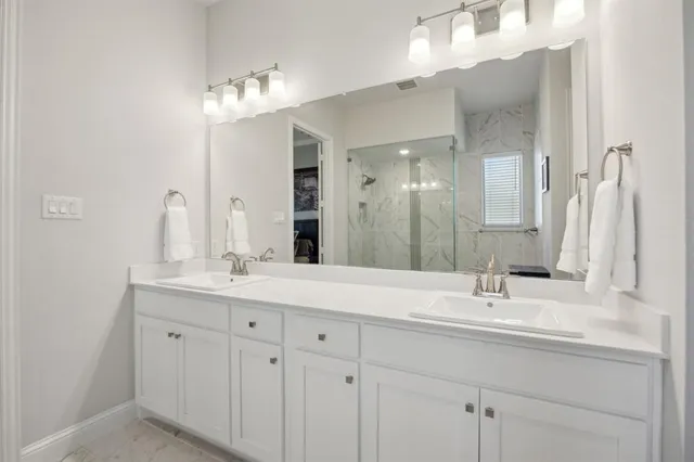 a bathroom with a sink double vanity and a mirror