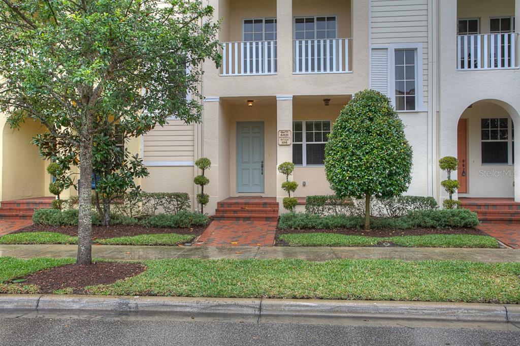 6021 Printery Street, Unit 106 Tampa, FL 33616 - Photo 2 of 23 a front view of a house with garden
