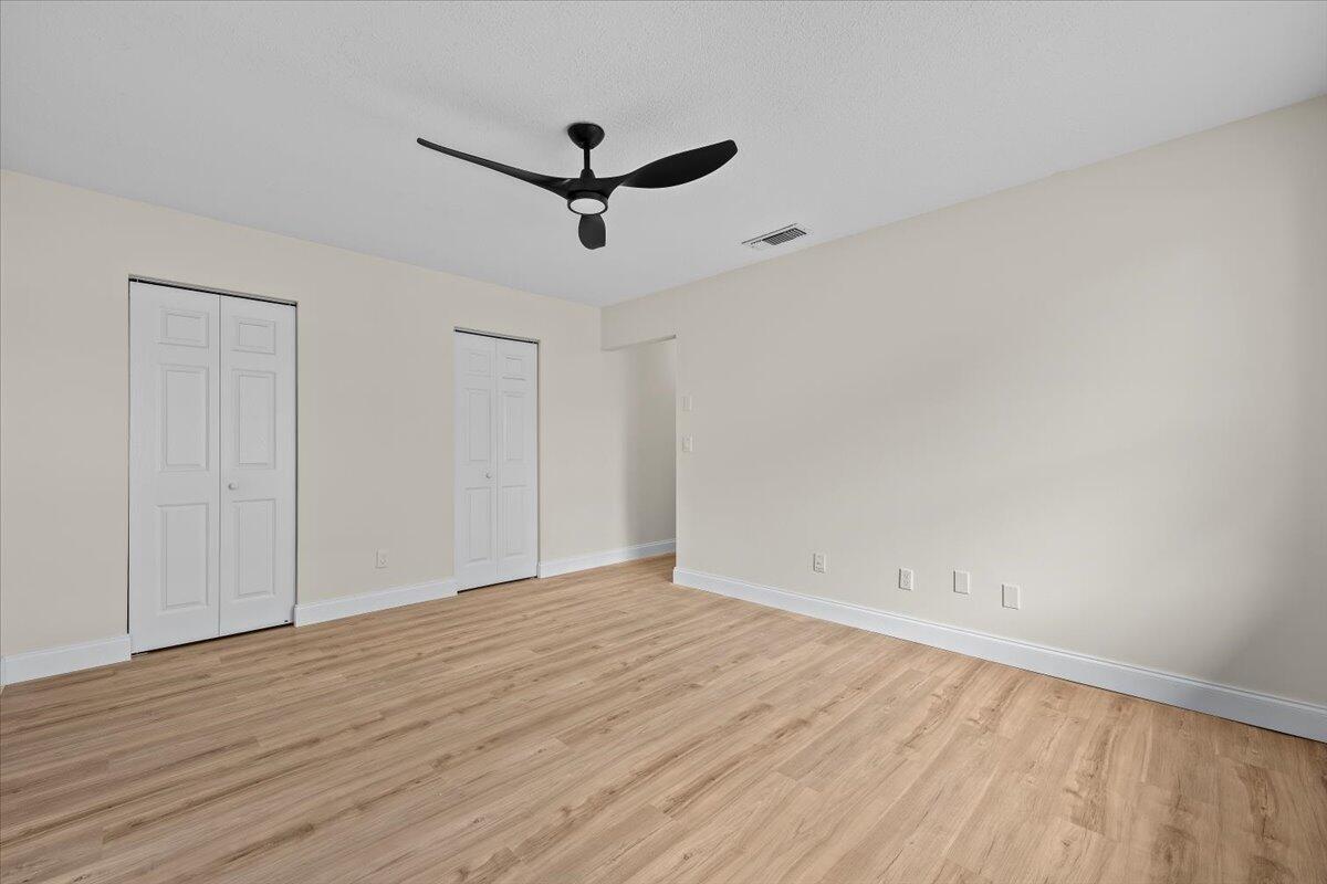 126 Wandering Trail Jupiter, FL 33458 - Photo 14 of 16 wooden floor in an empty room