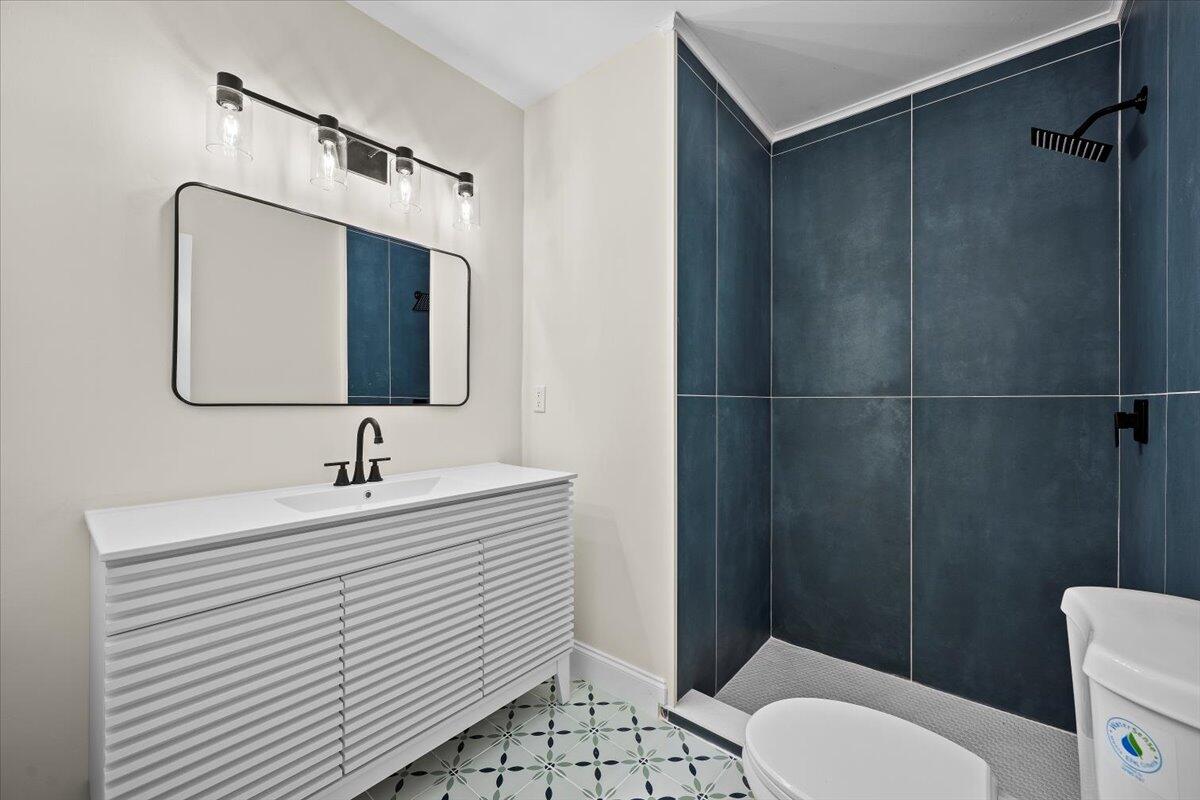 126 Wandering Trail Jupiter, FL 33458 - Photo 15 of 16 a bathroom with a sink toilet a mirror and shower