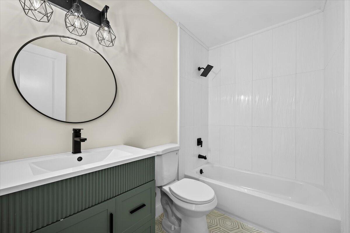 126 Wandering Trail Jupiter, FL 33458 - Photo 10 of 16 a bathroom with a sink mirror toilet and bathtub