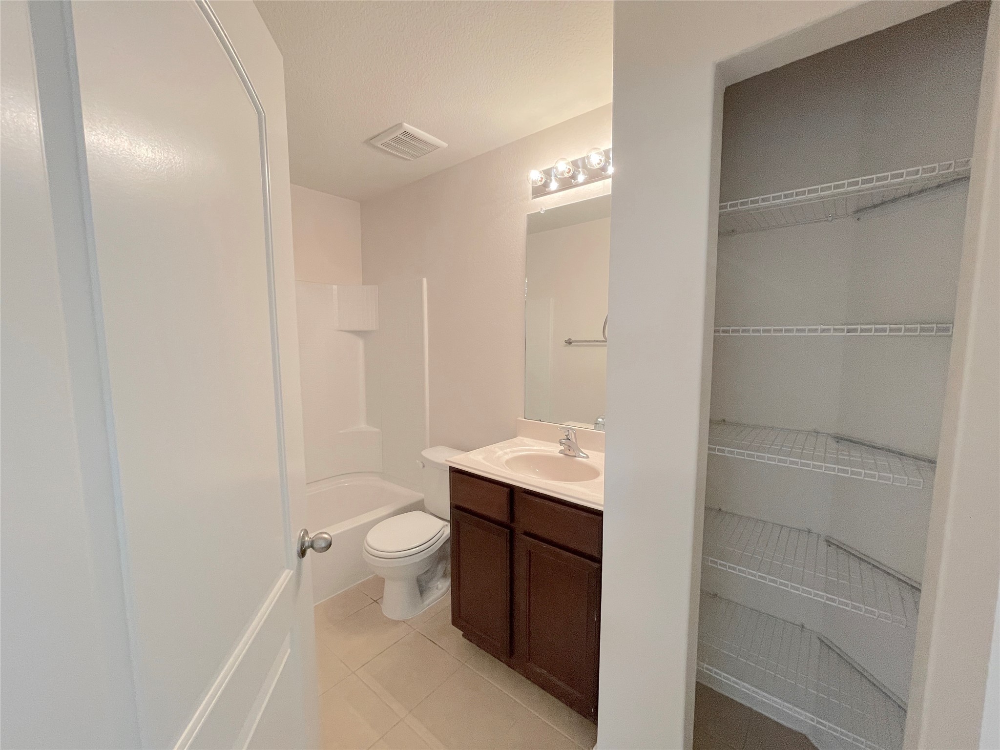 20714 Round Key Drive Hockley, TX 77447 - Photo 5 of 20 a bathroom with a granite countertop sink a toilet and shower