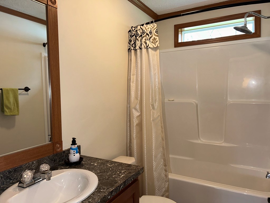 927 Lawsonham Road Rimersburg, PA 16248 - Photo 9 of 33 a bathroom with a granite countertop sink a mirror and a bathtub