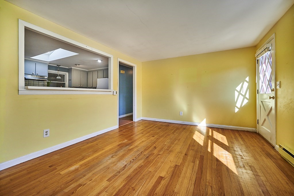 317 Florence Road Northampton, MA 01062 - Photo 3 of 38 a view of an empty room with wooden floor and a window