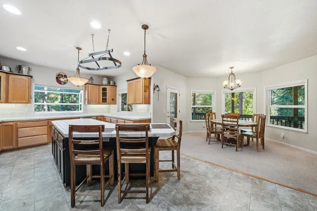 a kitchen with granite countertop stainless steel appliances a sink and cabinets