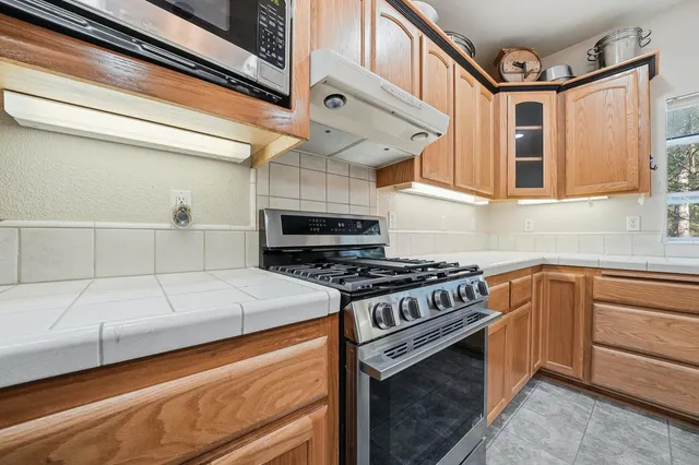 a view of a hallway with wooden floor and entryway