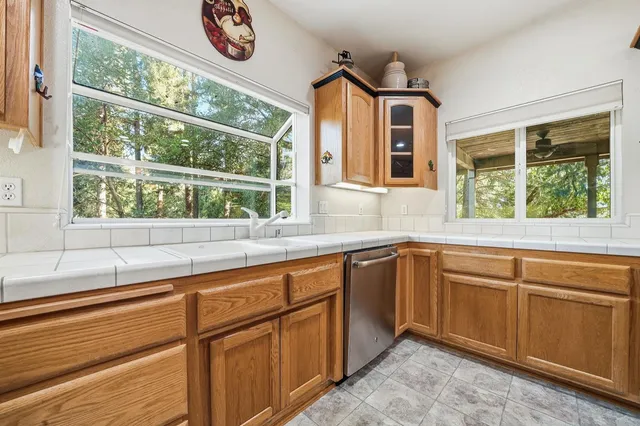 a bathroom with a granite countertop sink mirror and shower