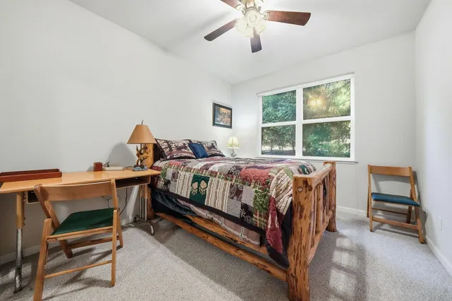 a bedroom with a bed and flat screen tv