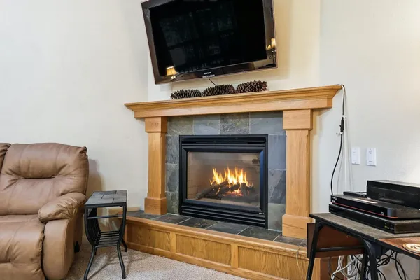 a living room with furniture and a dining table with wooden floor