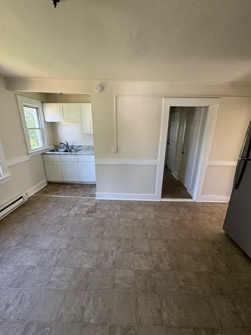 a view of room with window and hardwood floor