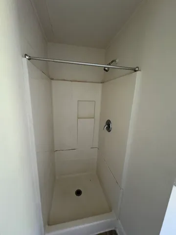 a bathroom with a glass shower door