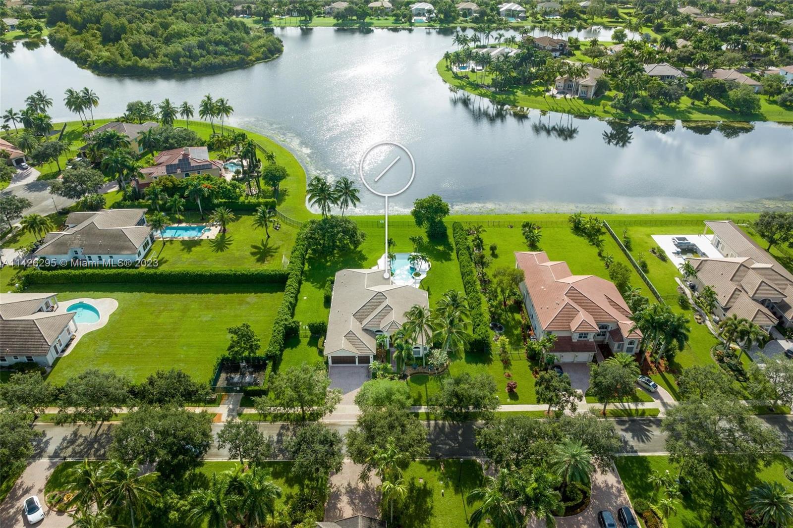 an aerial view of lake residential house with swimming pool and outdoor seating