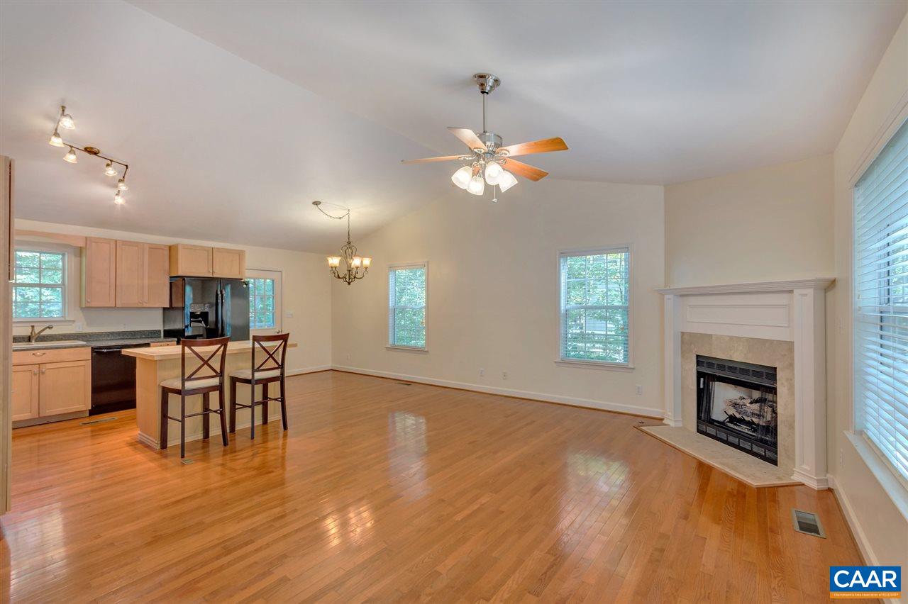 67 Amethyst Road Palmyra, VA 22963 - Photo 5 of 33 an open kitchen with furniture wooden floor and a fireplace