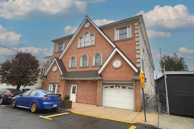 an empty room with wooden floor fireplace and windows