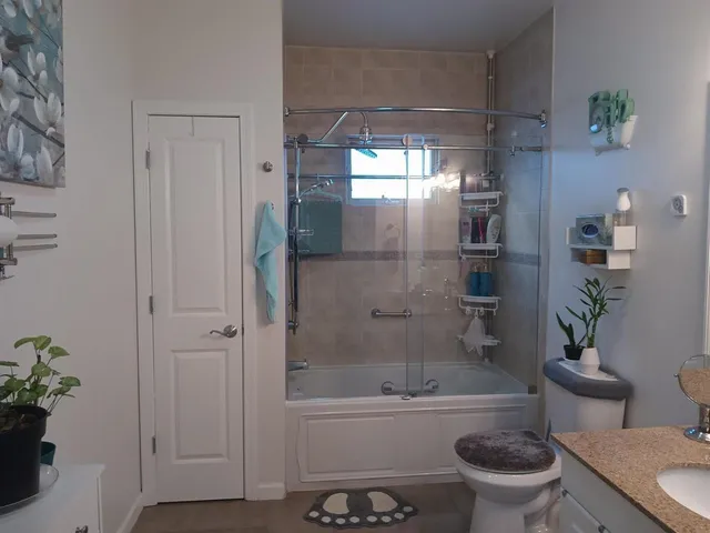 a bathroom with a sink a toilet and shower
