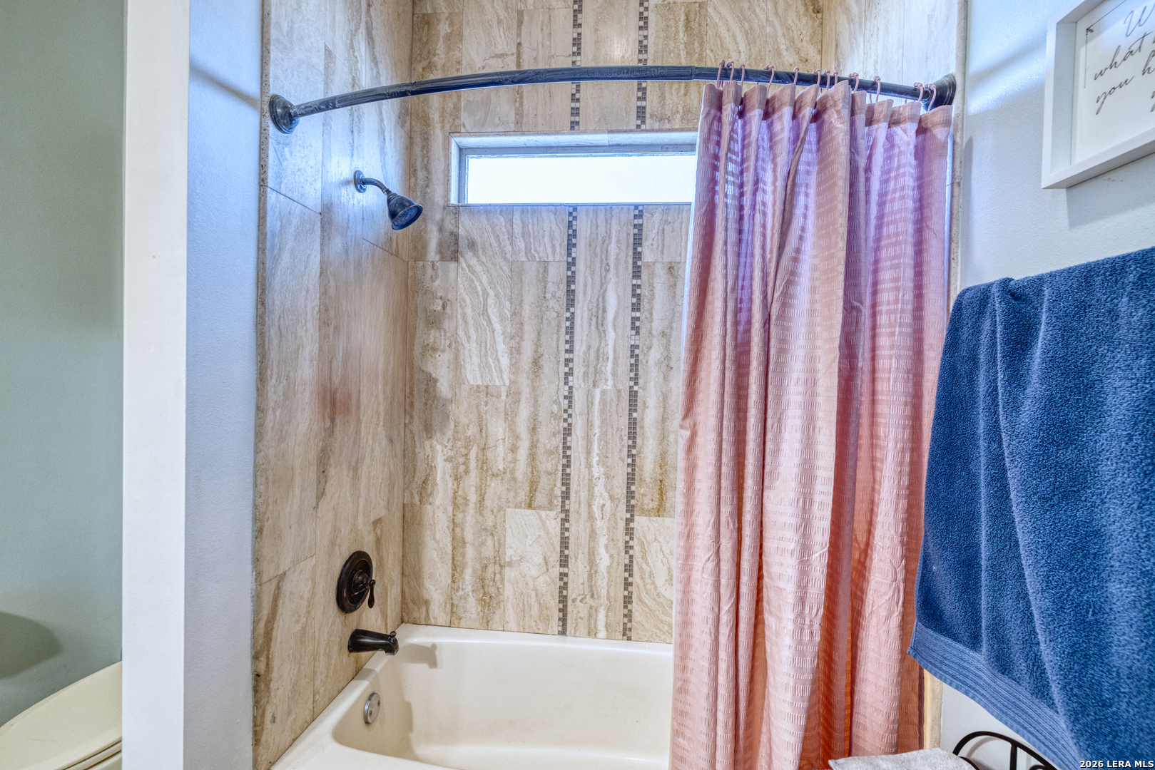 137 Sutton Place Uvalde, TX 78801 - Photo 26 of 31 a bathroom with a shower curtain and a bathtub