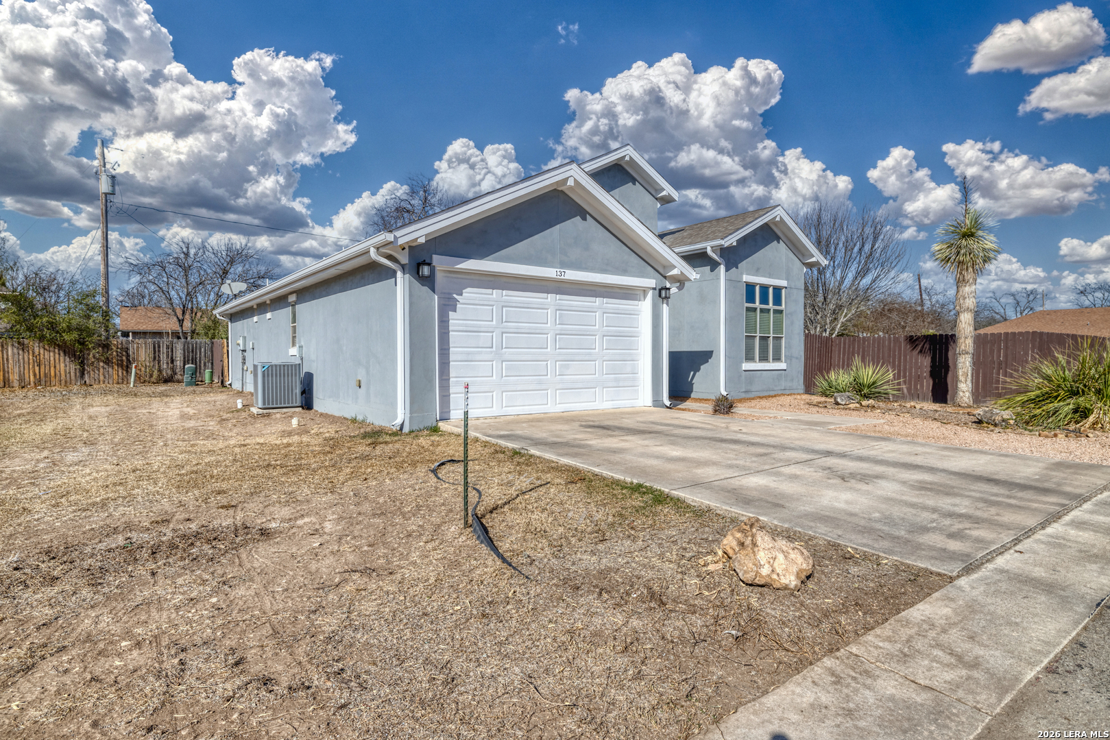 137 Sutton Place Uvalde, TX 78801 - Photo 6 of 31 a view of a house with a yard and a garage