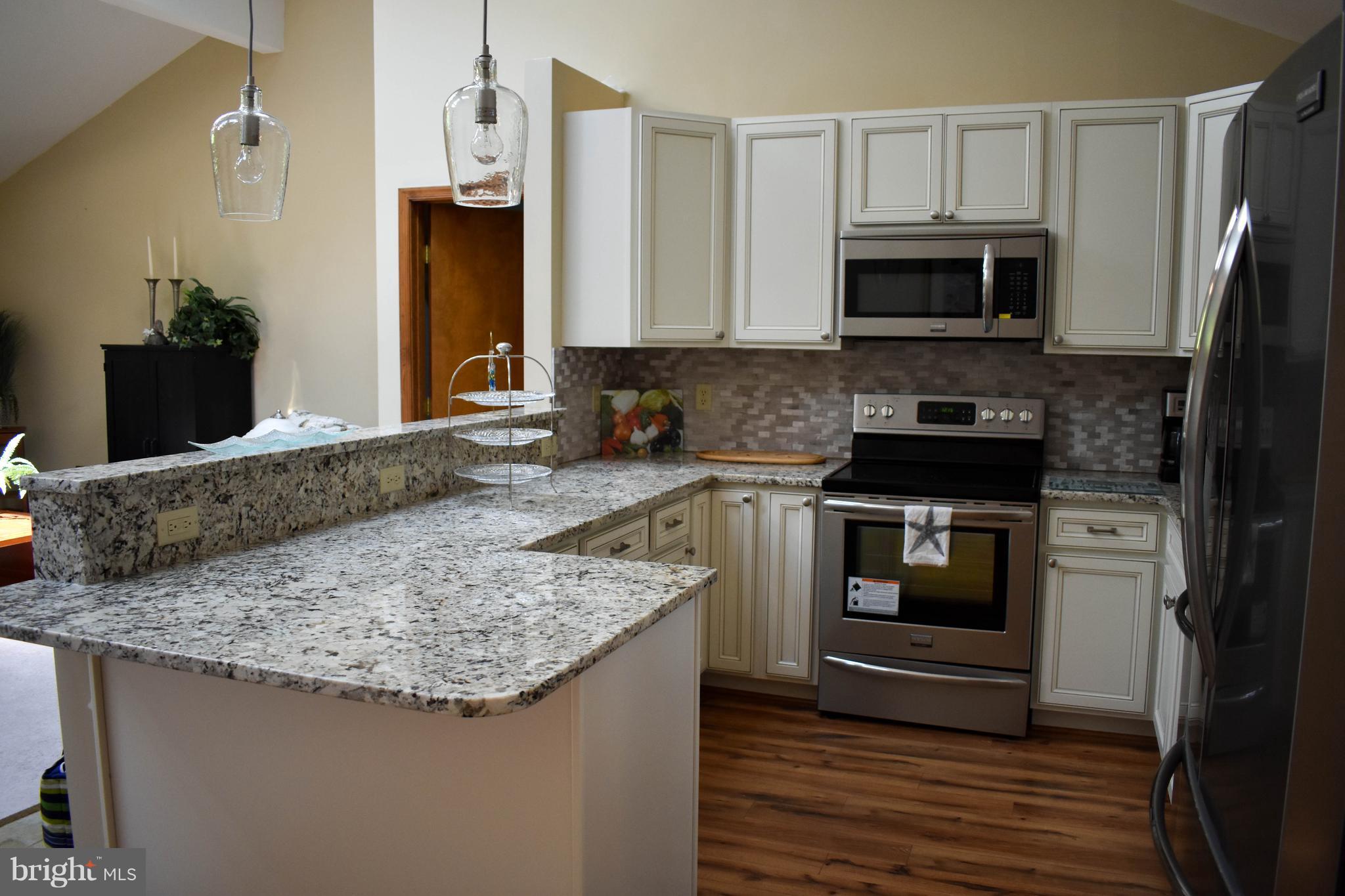 15 Sandyhook Road Ocean Pines, MD 21811 - Photo 9 of 29 a kitchen with stainless steel appliances granite countertop a sink stove and microwave