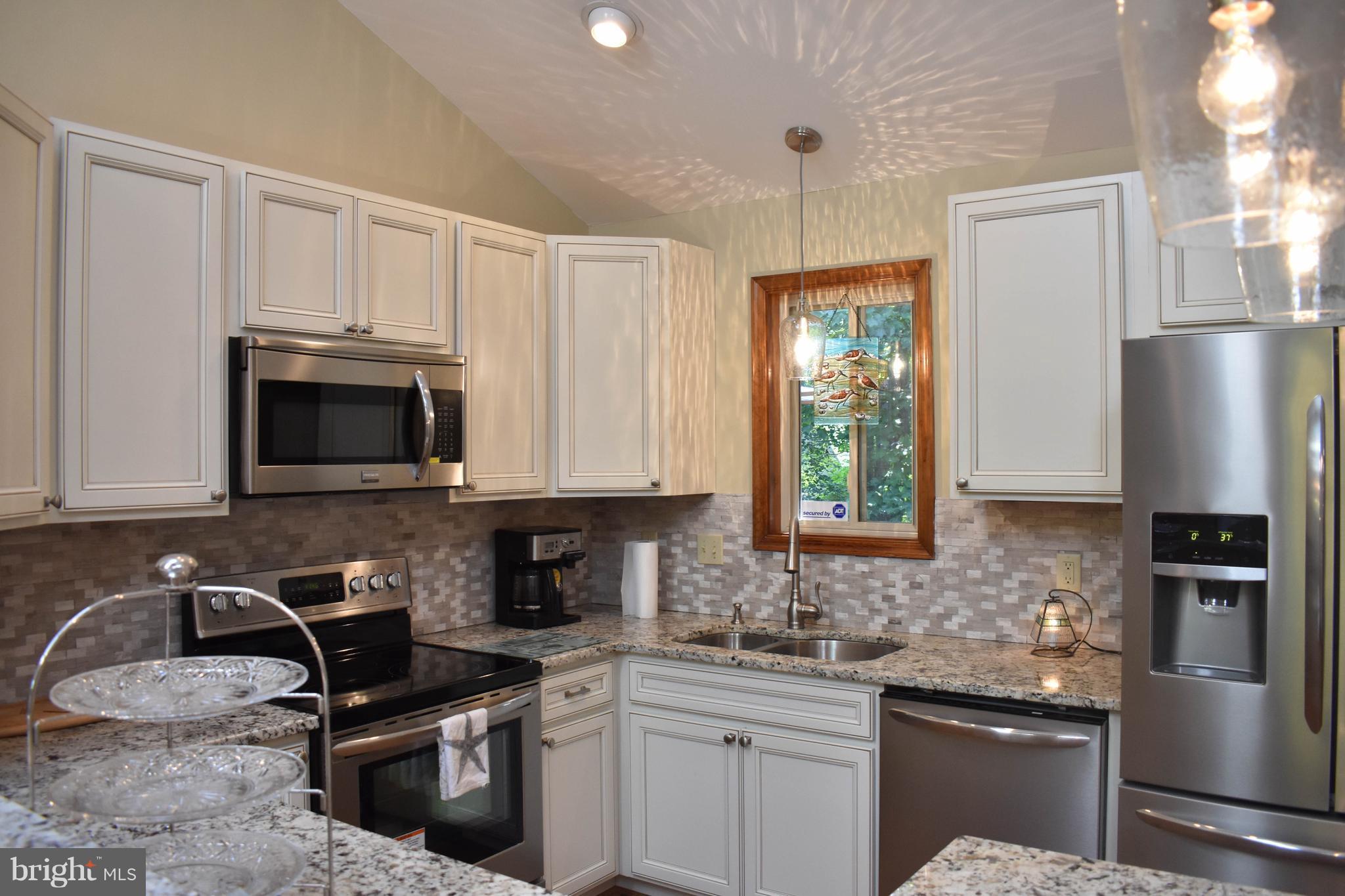15 Sandyhook Road Ocean Pines, MD 21811 - Photo 10 of 29 a kitchen with stainless steel appliances granite countertop a stove a sink dishwasher a refrigerator and a microwave