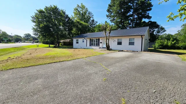a view of a house with pool and a yard