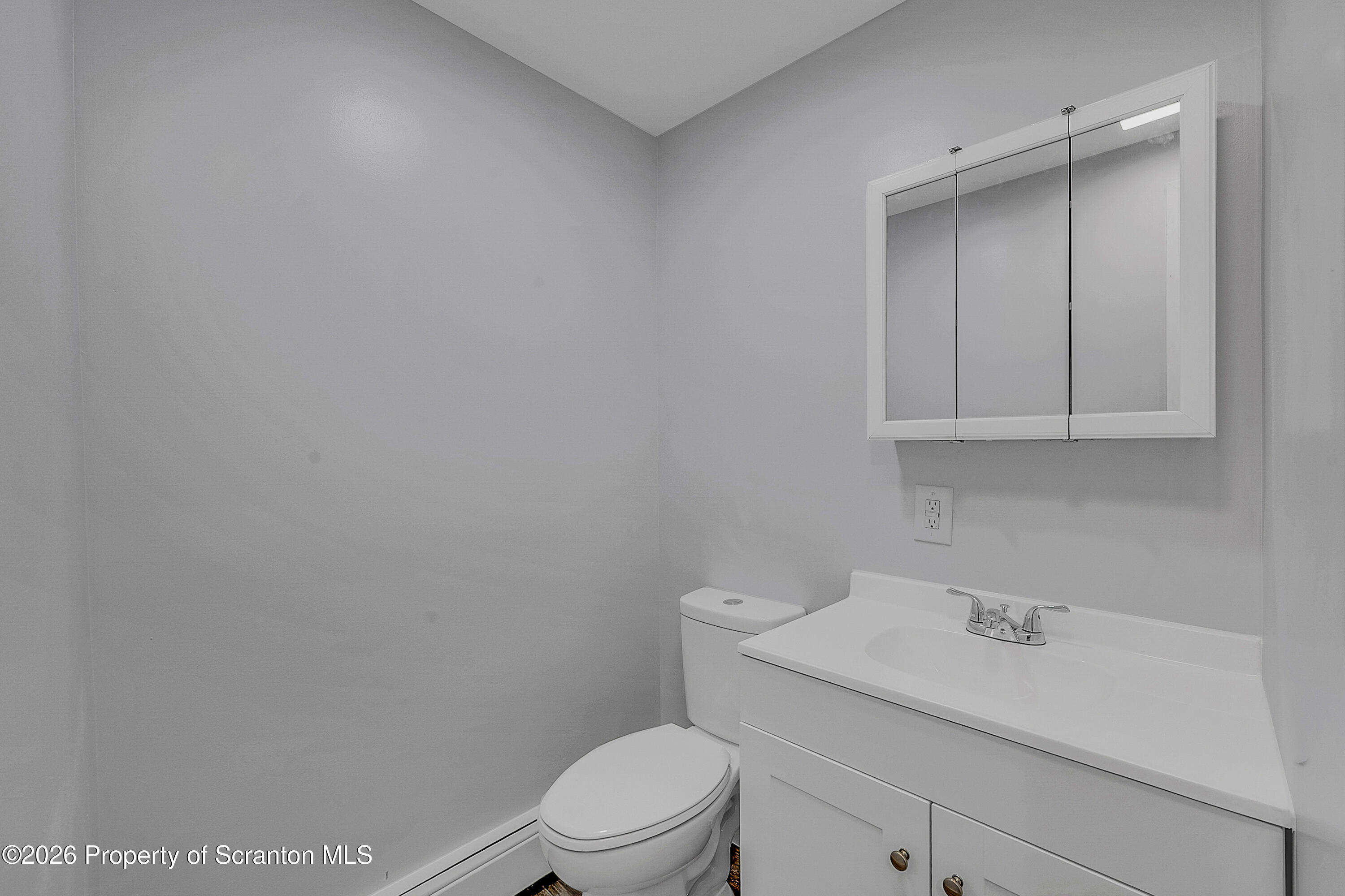 8 Green Ridge Street, Unit 1 Scranton, PA 18509 - Photo 14 of 15 a bathroom with a sink a toilet and vanity
